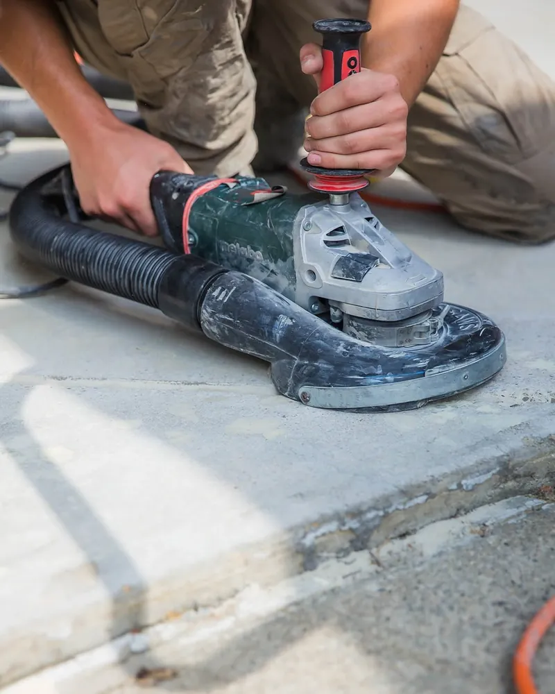 Comer & Cross installer diamond-grinding a concrete garage floor