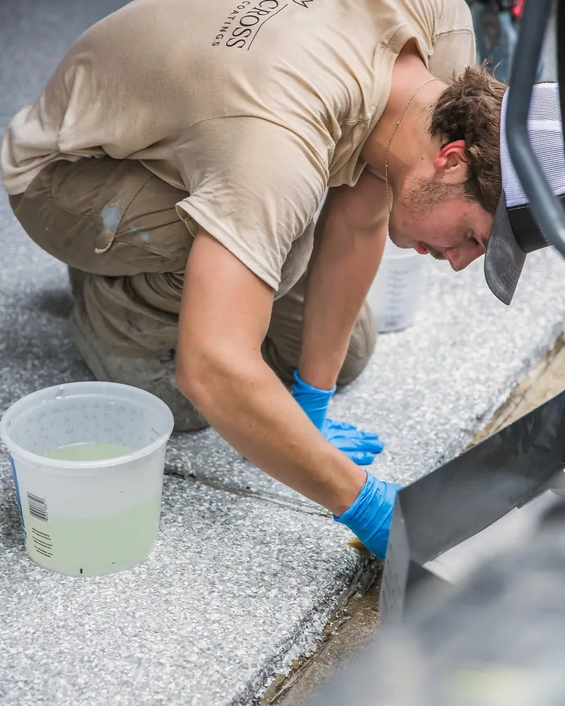 Comer & Cross installer finishing the edge of a coated floor by hand